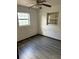 Bedroom with laminate flooring and natural light from two windows at 411 Keat Ave, Auburndale, FL 33823
