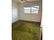 Bedroom with a window and green carpet at 411 Keat Ave, Auburndale, FL 33823