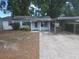 Modest single-story home with a carport and small front porch; showing signs of wear at 411 Keat Ave, Auburndale, FL 33823