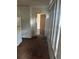 Interior space featuring white cabinets, a refrigerator, and an open doorway at 411 Keat Ave, Auburndale, FL 33823
