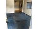 Basic living room featuring blue carpet and an adjacent room at 411 Keat Ave, Auburndale, FL 33823