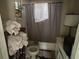 Small bathroom with outdated fixtures, a shower and a build up of items at 445 Choctaw Ave, Lakeland, FL 33815