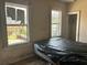 Shows a bedroom with two windows and poor upkeep at 445 Choctaw Ave, Lakeland, FL 33815