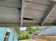 Exterior view of home's soffit with damaged wood, and backyard visible at 445 Choctaw Ave, Lakeland, FL 33815