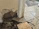 Damaged flooring with missing tiles next to wall damage at 445 Choctaw Ave, Lakeland, FL 33815
