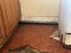 Damaged floor tiles next to cabinets, showing water damage and decay at 445 Choctaw Ave, Lakeland, FL 33815