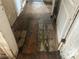 Hallway with unfinished, damaged floors and multiple doorways needs repair at 445 Choctaw Ave, Lakeland, FL 33815