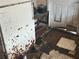 Damaged flooring and rusted refrigerator near doorway at 445 Choctaw Ave, Lakeland, FL 33815