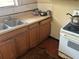 Kitchen sink, stove, and deteriorated flooring at 445 Choctaw Ave, Lakeland, FL 33815