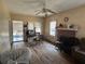 Living room features a fireplace, hardwood floors, and a ceiling fan; Needs cleaning at 445 Choctaw Ave, Lakeland, FL 33815