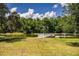 Scenic view of a community pond with a small dock and fountain at 4963 Colonnades Club Blvd, Lakeland, FL 33811