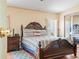 Bedroom featuring carpet flooring, ceiling fan and a large bed with a wood headboard at 5027 Forest Crest Dr, Lakeland, FL 33810