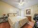 Bedroom with a ceiling fan, a bed with patterned bedding, and a window at 5027 Forest Crest Dr, Lakeland, FL 33810