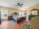 Bedroom featuring carpet flooring, ceiling fan and a large bed with a wood headboard at 5027 Forest Crest Dr, Lakeland, FL 33810