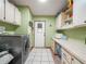 Laundry room featuring tile floor, white cabinets and countertops at 5027 Forest Crest Dr, Lakeland, FL 33810