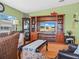 Cozy living room featuring a large entertainment center, plush seating, and a decorative coffee table at 5027 Forest Crest Dr, Lakeland, FL 33810
