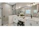 Bathroom with double vanity, large mirror, and a separate glass-enclosed shower at 5374 Clubhouse Hills Ln, Lakeland, FL 33812