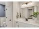 Bright bathroom featuring a white vanity, large mirror, and walk-in shower with gray tile at 5374 Clubhouse Hills Ln, Lakeland, FL 33812