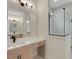 Modern bathroom featuring a vanity, large mirror, modern lighting, and a glass-enclosed shower at 5374 Clubhouse Hills Ln, Lakeland, FL 33812