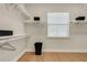 Walk-in closet with white shelving, hardwood floors, and a window for natural light at 5374 Clubhouse Hills Ln, Lakeland, FL 33812
