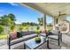 Inviting covered patio with comfortable seating, a ceiling fan, and view of the backyard at 5374 Clubhouse Hills Ln, Lakeland, FL 33812