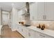 Modern kitchen featuring white cabinets, quartz countertops, and a stainless steel range hood at 5374 Clubhouse Hills Ln, Lakeland, FL 33812