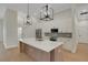 Spacious kitchen with a large island, stainless steel appliances, modern lighting, and hardwood floors at 5374 Clubhouse Hills Ln, Lakeland, FL 33812
