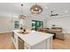 Elegant kitchen open to the living room featuring a large island, modern appliances, and stylish decor at 5374 Clubhouse Hills Ln, Lakeland, FL 33812