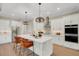Elegant white kitchen featuring a large center island, modern appliances, and stylish pendant lighting at 5374 Clubhouse Hills Ln, Lakeland, FL 33812