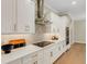 Well-equipped kitchen features white cabinets, stainless steel appliances, and a sleek cooktop at 5374 Clubhouse Hills Ln, Lakeland, FL 33812