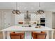 Modern kitchen with white cabinets, stainless steel appliances, and a large island with seating at 5374 Clubhouse Hills Ln, Lakeland, FL 33812