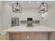 Kitchen showcasing a large island, stainless steel appliances, modern pendant lighting, and custom cabinets at 5374 Clubhouse Hills Ln, Lakeland, FL 33812