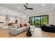 Open-concept living room and kitchen with modern decor, stylish furniture, and a seamless indoor-outdoor flow at 5374 Clubhouse Hills Ln, Lakeland, FL 33812