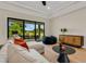 Spacious living room featuring a comfortable sectional sofa, large sliding glass doors and modern decor at 5374 Clubhouse Hills Ln, Lakeland, FL 33812