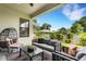 Covered patio showcasing stylish outdoor seating, ceiling fan and view of the green backyard at 5374 Clubhouse Hills Ln, Lakeland, FL 33812