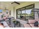 Covered patio with comfortable seating, an outdoor kitchen, and a view of the backyard at 5374 Clubhouse Hills Ln, Lakeland, FL 33812