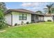 Well-maintained backyard with a screen porch, landscaping, and lush green grass at 628 Wexford Ct, Winter Haven, FL 33884