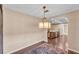 The dining area with a modern light fixture and hardwood floors adjacent to the kitchen at 628 Wexford Ct, Winter Haven, FL 33884