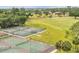 Overhead view of several well-maintained tennis courts with beautiful green landscaping nearby at 628 Wexford Ct, Winter Haven, FL 33884