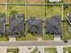 Overhead image of homes with neat landscaping, symmetrical roofs, and neighborhood street view at 6627 Ridgemont Rd, Lakeland, FL 33813