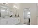 Bathroom featuring double vanity with a marble countertop, modern lighting, and access to the main bedroom at 6627 Ridgemont Rd, Lakeland, FL 33813
