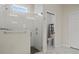 Modern bathroom with glass-enclosed shower, pebble floor, and adjacent toilet area at 6627 Ridgemont Rd, Lakeland, FL 33813