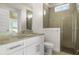 Bathroom featuring glass enclosed shower, marble countertops and flooring, and modern fixtures at 6627 Ridgemont Rd, Lakeland, FL 33813