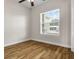 A bright bedroom with hardwood floors and a window offering natural light at 6627 Ridgemont Rd, Lakeland, FL 33813
