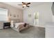 Bedroom featuring ceiling fan, ensuite bathroom, and neutral carpet at 6627 Ridgemont Rd, Lakeland, FL 33813