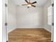 Bright, empty room with wood-look tile, ceiling fan and a window allowing natural light at 6627 Ridgemont Rd, Lakeland, FL 33813