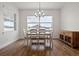 Dining room featuring wood floors, a modern chandelier, and natural light from the windows at 6627 Ridgemont Rd, Lakeland, FL 33813