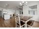Spacious dining area adjoins open kitchen and features stylish chandelier and large bright window at 6627 Ridgemont Rd, Lakeland, FL 33813