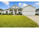 Beautiful home with a well-maintained lawn, brick-paved driveway, and inviting front porch at 6627 Ridgemont Rd, Lakeland, FL 33813