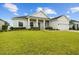 Well-kept home with a green lawn, stone-accented columns, and an attached two-car garage at 6627 Ridgemont Rd, Lakeland, FL 33813